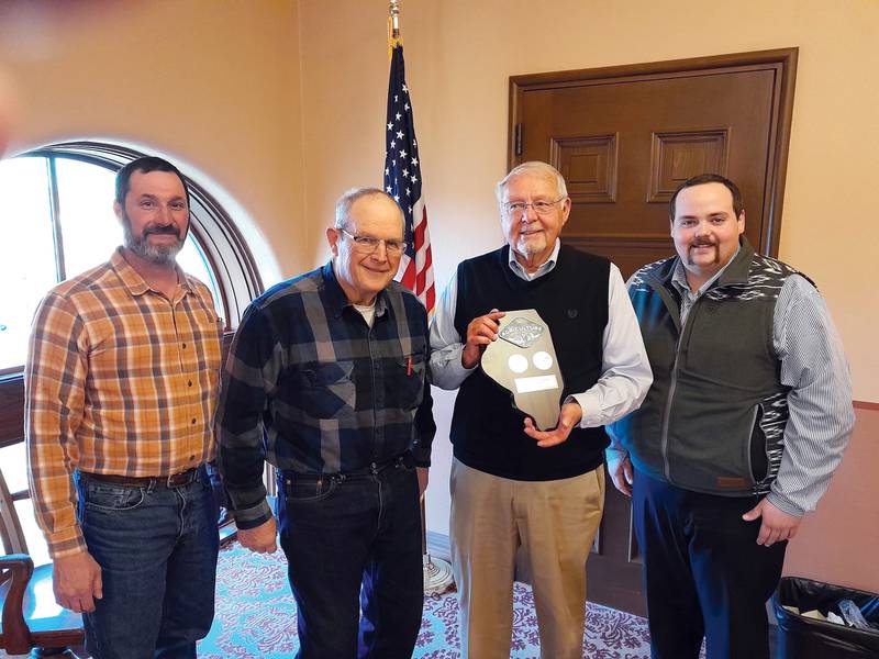 Ogle County Farm Bureau President Keith Poole presents the pro-agriculture designation to John Finfrock, Ogle County Board Chairman, following the passage of the pro-agriculture resolution in February. Also pictured are: Lyle Hopkins, County Board Ag Committee Chair; and Ryan Reeverts, County Board and County Farm Bureau director.