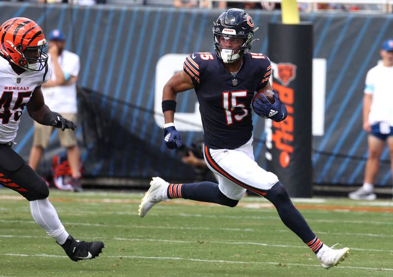 Chicago Bears wide receiver Rome Odunze outruns Cincinnati Bengals linebacker Maema Njongmeta on an end around during their game in August 2024 at Soldier Field in Chicago.