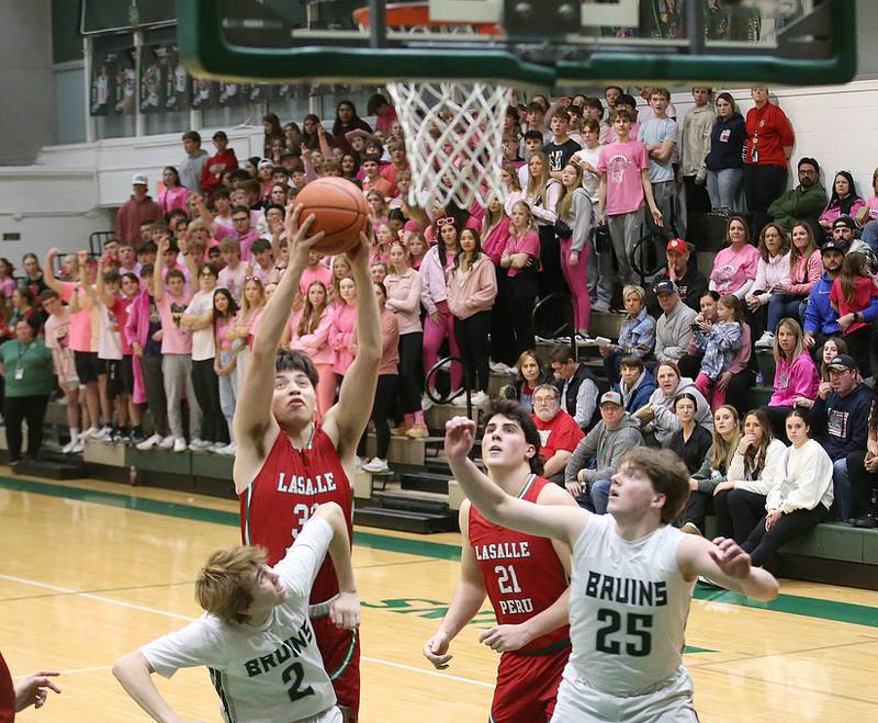 L-P's Eric Sotelo grabs a rebound over St. Bede's Kaden Nauman and teammate Jake Miglorini on Wednesday, Feb. 14, 2024 at St. Bede Academy.