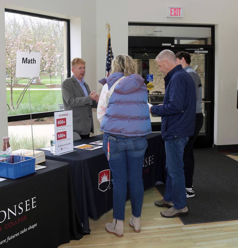 Waubonsee Community College Business Professor Andy Clements talks to the Hoheisel Family of Sugar Grove at the Transfer and Career Open House at the Sugar Grove Campus on April 20, 2024.