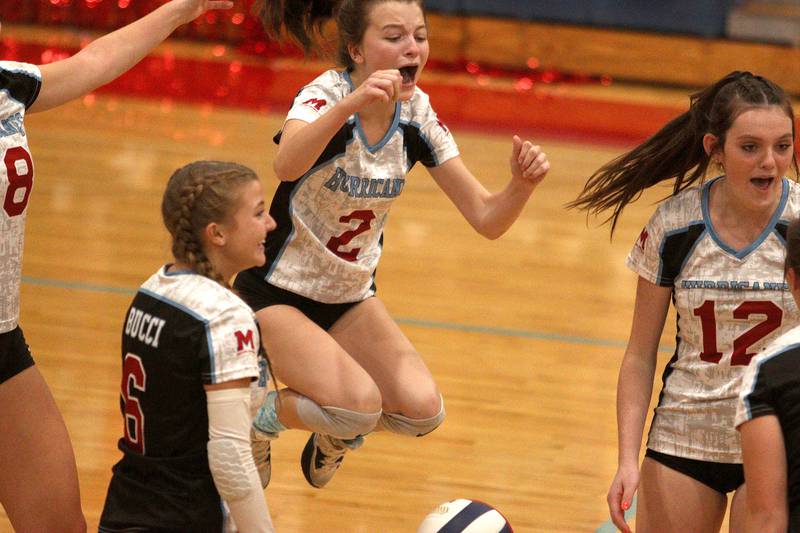 Marian Central’s Jillian Winkelman and the Hurricanes get revved up as they rally against Grayslake North in girls volleyball at Woodstock Monday. The host Hurricanes fell in two sets to the Knights.