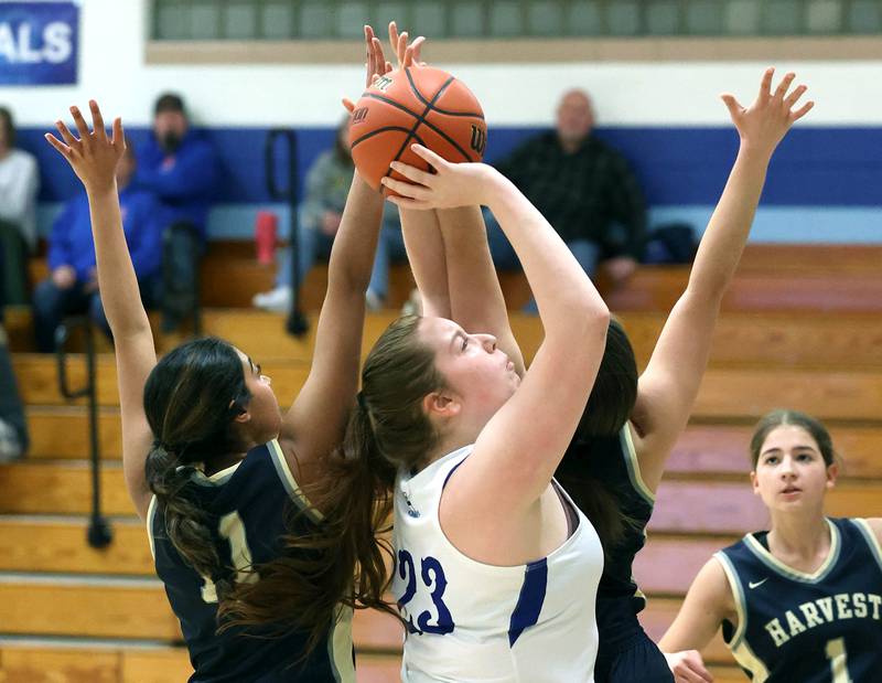 Hinckley-Big Rock’s Sami Carlino shoots between two Harvest Christian defenders Monday, Jan. 8, 2023, during their game at Hinckley-Big Rock High School.