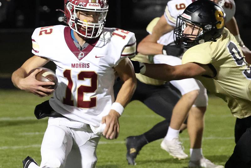 Morris' Brady Varner tries to get outside of Sycamore's Caden O’Donnell during their game Friday, Oct. 18, 2024, at Sycamore High School. Sycamore's Kevin Lee