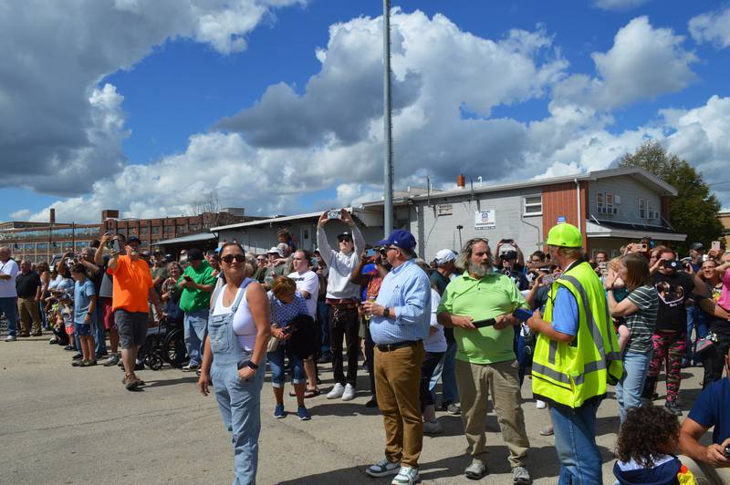 Sterling Mayor Diana Merdian (center-left in pinstripe blue overalls) stands in front of a crowd of people viewing the Union Pacific Big Boy Steam Engine No. 4014 during its whistle stop on Friday, Sept. 6, 2024, at the Sterling Marketplace.