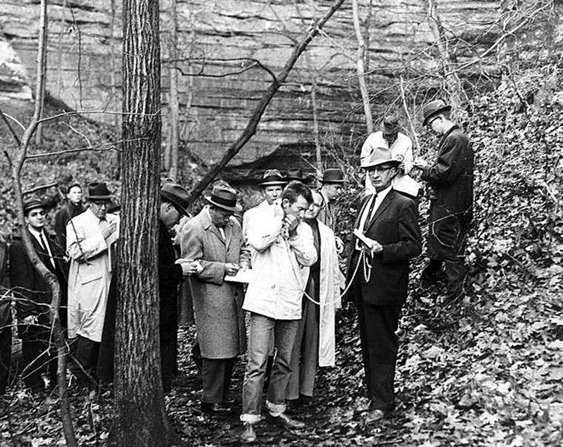 Surrounded by reporters on Nov. 17, 1960, Chester Weger is held in chains by Sheriff Ray Eutsey at Starved Rock State Park's St. Louis Canyon. Weger re-enacted the killing of three women from Riverside, which occurred March 14, 1960.