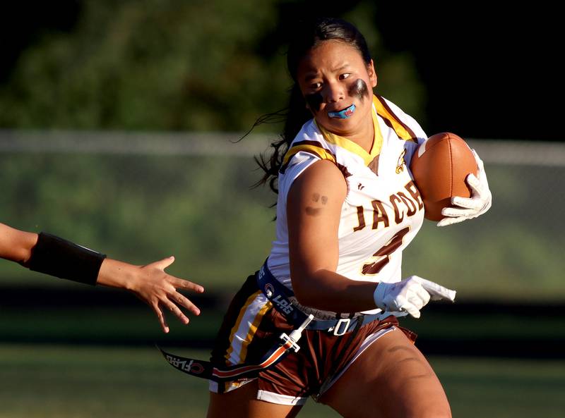 Jacobs’  Sophia Acot runs the ball in varsity flag football on Tuesday, Sept. 3, 2024, at Dundee-Crown High School in Carpentersville.