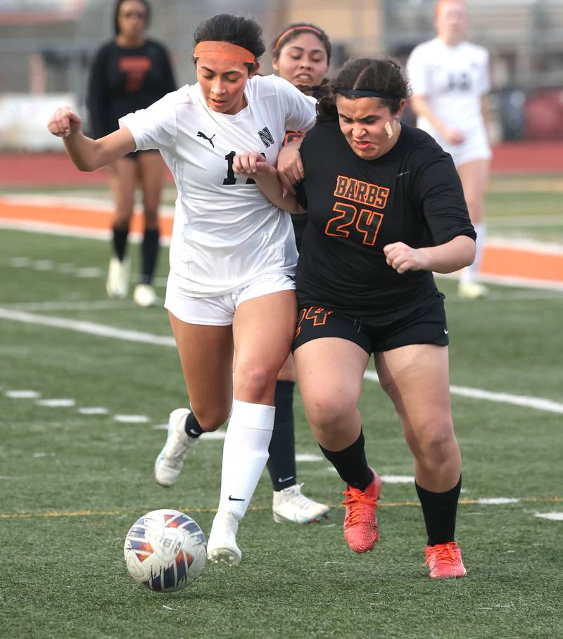 DeKalb’s Alexia Ortiz and Belvidere North's Isabella  Phommachanh fight for possession during their game Tuesday, March 12, 2024, at DeKalb High School.