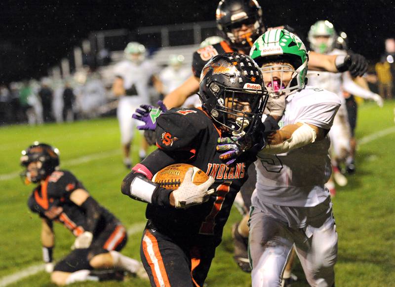 Sandwich running back Simeion Harris (1) stiff arms Ridgewood defender Majd Saleh (9) for his first touchdown during a varsity football game at Sandwich High School on Friday, Oct. 27, 2023.