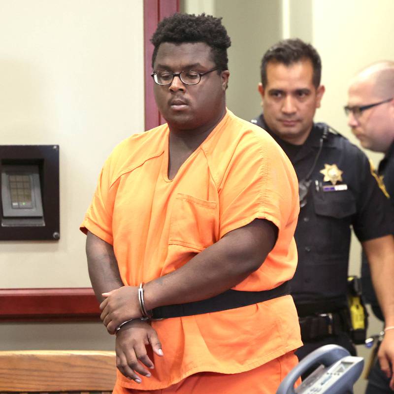 Timothy M. Doll, 29, of DeKalb, is escorted by DeKalb County Sheriff’s officers as he enters courtroom 210 in the DeKalb County Courthouse Wednesday, June 14, 2023, for his arraignment on several charges including two counts of first-degree murder in the death of 15-year-old Gracie Sasso-Cleveland of DeKalb.