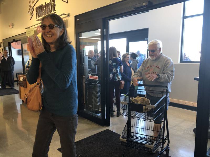 Don and Lorene Henning walk into Food Shed Co-op during its grand opening in Woodstock May 15, 2024.