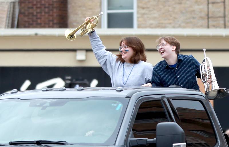 Olivia Burgan and Elliot Johnson represent Tri-M during the St. Charles North’s annual homecoming parade on Main Street through downtown St. Charles on Thursday, Oct. 19, 2023.