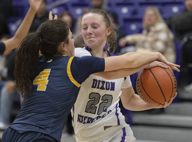 Sterling’s Maggie Rowzee reaches for the ball handled by Dixon’s Katie Drew Tuesday, Feb. 13, 2024 during a regional semifinal at Rochelle.