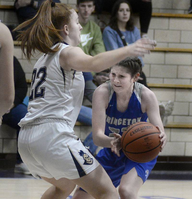 Princeton’s Camryn Driscoll works to get a pass away from Marquette’s Maera Jimenez during the 2nd period in Bader Gymnasium on Saturday, Jan. 7, 2023 at Marquette High School.