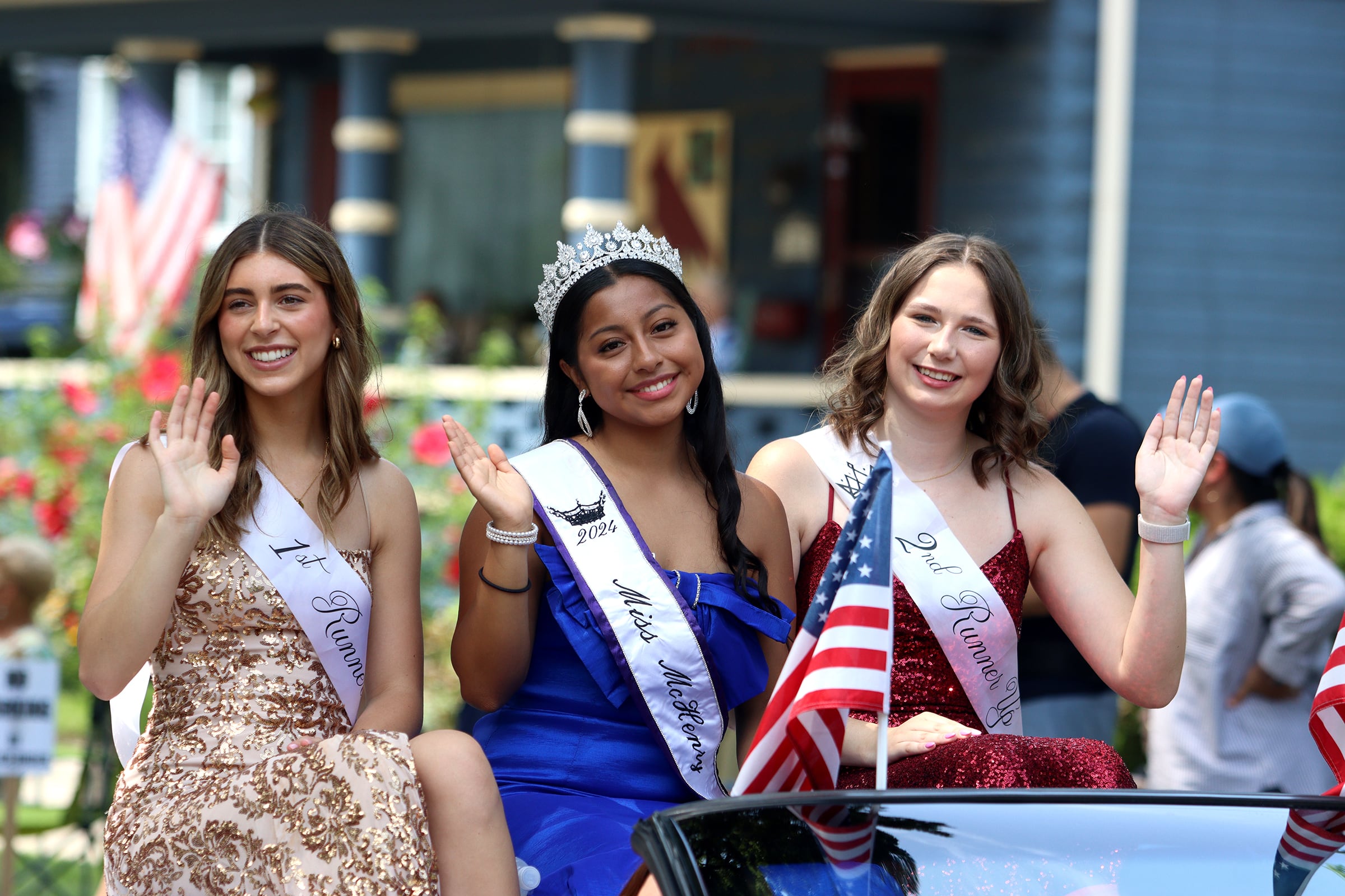 Miss McHenry Jocelyn Bello, center, and runners-up Trinity Dunford, left, and Samantha Andresen, right, ride in a convertible as part of the Fiesta Days parade along Main Street in McHenry Sunday.