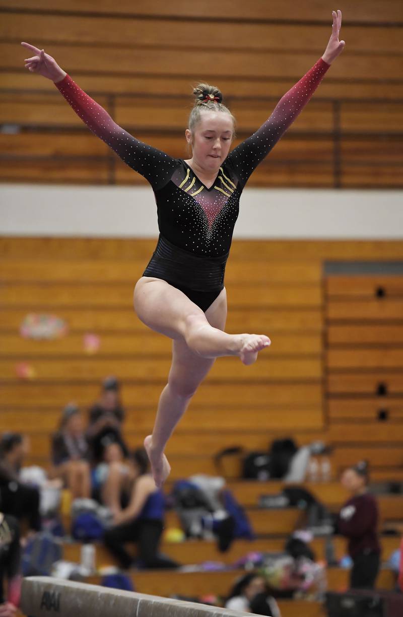 Batavia’s Delia Fulton on the balance beam at the DuKane Conference girls gymnastics meet in Carol Stream Wednesday, Jan. 24, 2024.