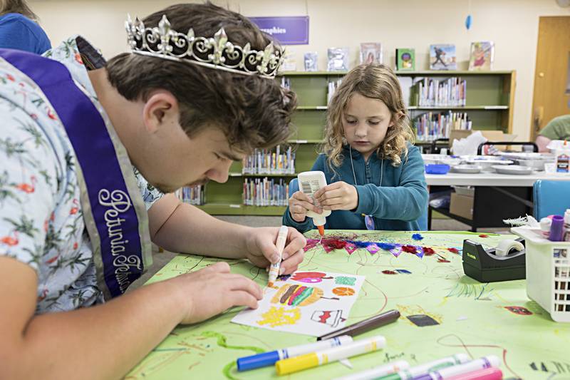 Petunia male attendant Logan Devine gets busy on his craft along with Ella Langenfeld, 6, Wednesday, June 28, 2023 at the Dixon library.