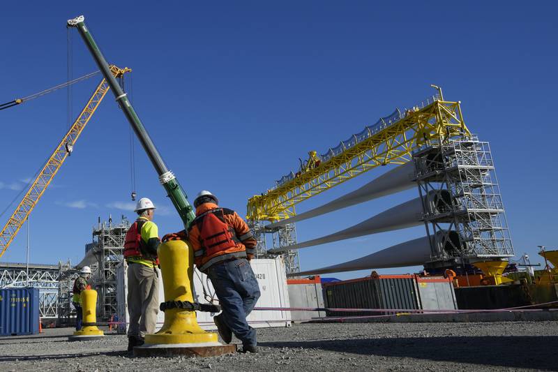 File - A generator and its blades are prepared to head to the open ocean for the South Fork Wind farm from State Pier in New London, Conn., Dec. 4, 2023. On Thursday, the government issues the first of three estimates of GDP growth in the United States during the October-December quarter.(AP Photo/Seth Wenig, File)