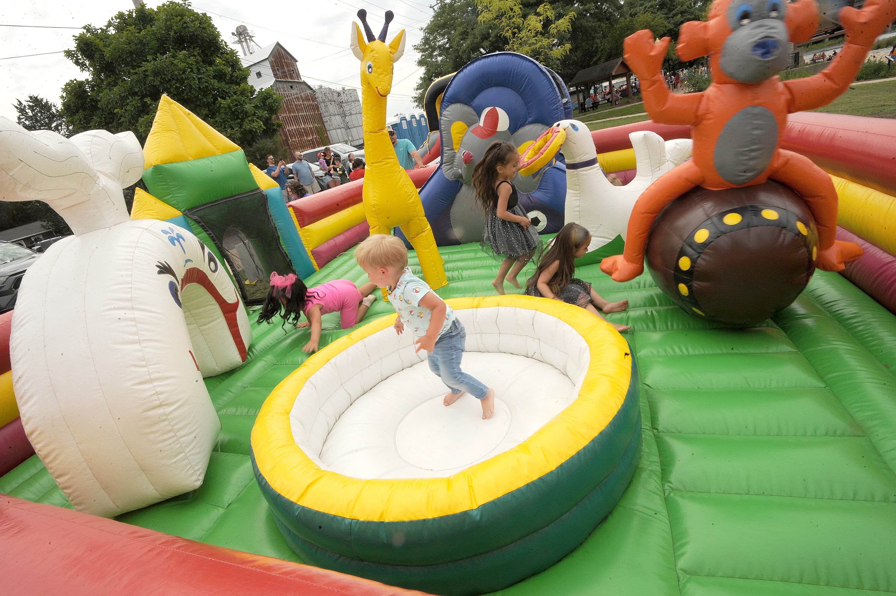 Kids frolic in a large bounce town during Riverfest on Hydraulic Avenue in Yorkville on Saturday, July 20, 2024.