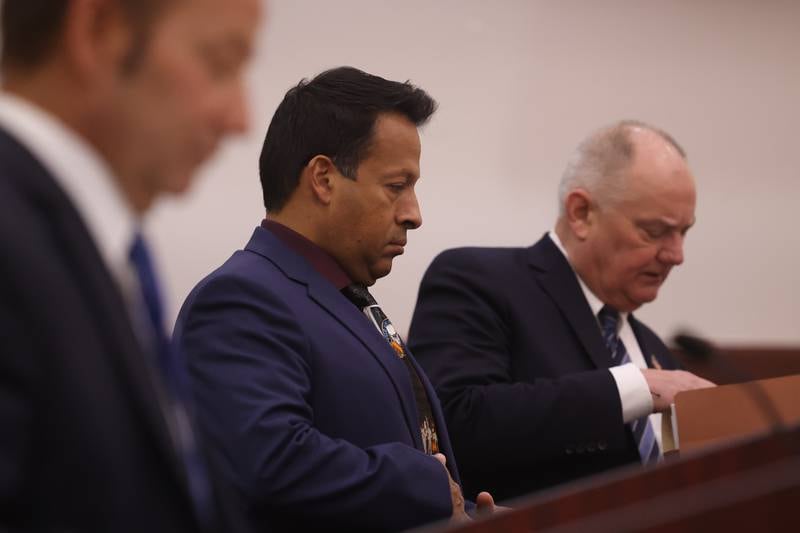 Retired Joliet police sergeant Javier Esqueda, center, stands in the courtroom at the Kendall County Courthouse in Yorkville. Esqueda is charged with official misconduct for accessing and leaking the police squad video of the arrest of Eric Lurry, 37, who died following his arrest on drug charges in January 2020.