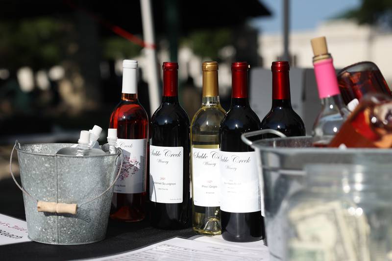 Bottles of wine sit on the Sable Greek Winery of Plainfield table at the Wine, Jazz and Arts Fest at Bicentennial Park in Joliet on Saturday, Aug. 19, 2023.