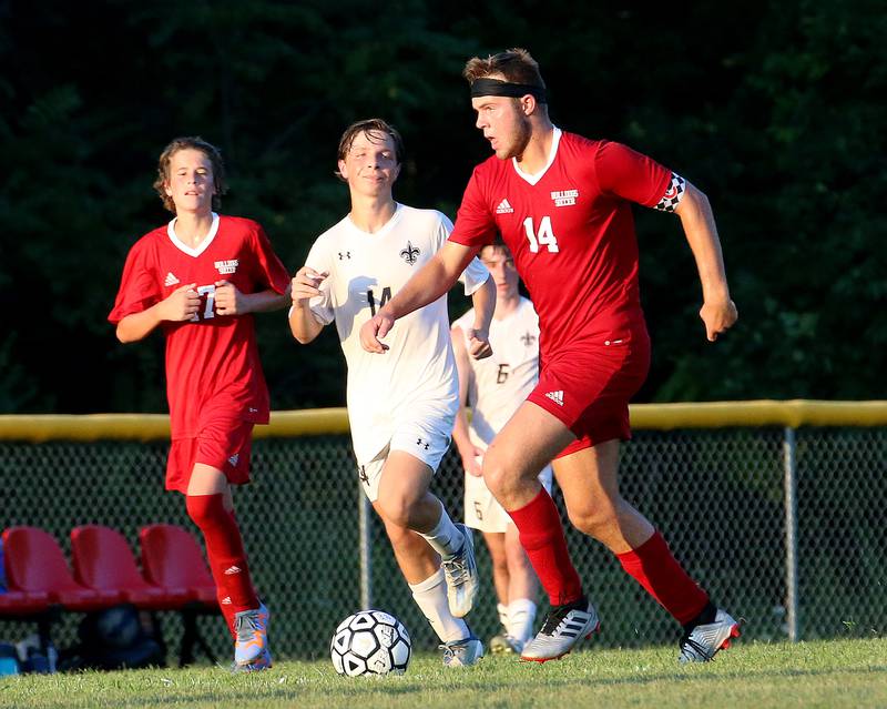 Streator's Landon Muntz kicks the ball down the field past Bloomington Central Catholic's Sam Allen on Wednesday, Aug. 23, 2023 at St. James Street Recreation Area in Streator.