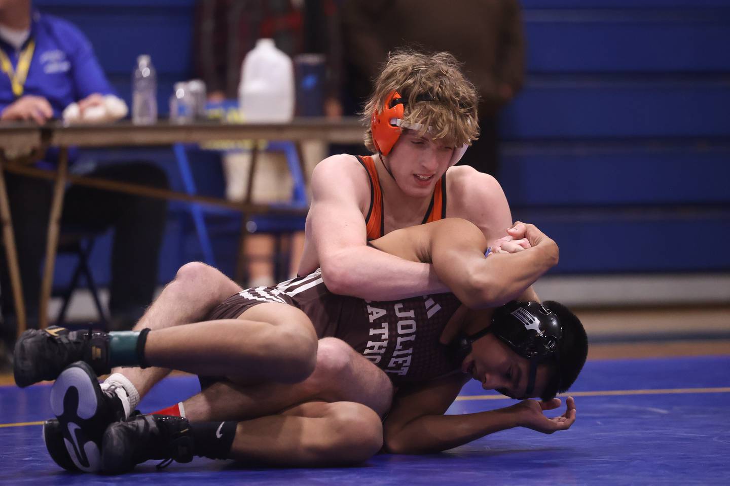 Minooka’s Cale Stonitsch works over Joliet Catholic’s Damien Flores in the Class 3A Joliet Central Regional 132 pound Championship match on Saturday, Feb. 3rd 2024 in Joliet.