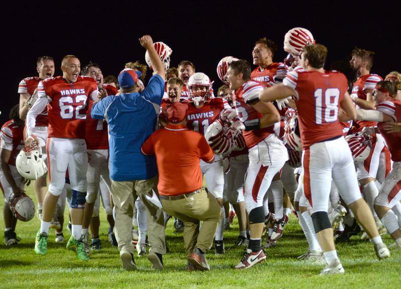 Oregon head coach Broc Kundert celebrates with his team after the Hawks edged Genoa-Kingston 3-0 on Friday, Sept. 13, 2024 at Landers-Loomis Field in Oregon.