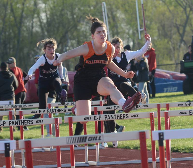 Milledgeville's Lynn Stringini clears a hurdles as she heads to the finish line in first place in the 100 hurdles at the Ed Schmidt Invitational Track Meet at Erie High School on Friday, April 19, 2024.