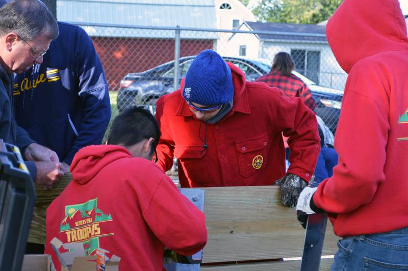 Gab Buelvas, 17, of Dixon, (blue hat), observes one of the volunteers he lead in building a gaga ball pit for Vaile Park on Saturday, Oct. 7, 2023. The gaga ball pit was Buelvas' Eagle Scout project.