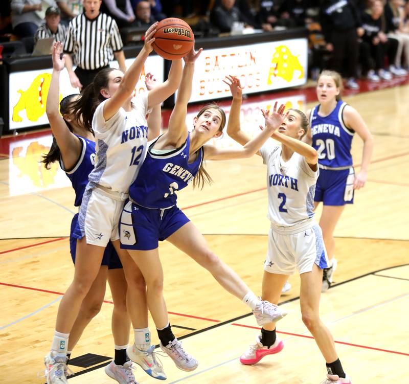 St. Charles North’s Riley Barber (left) and Geneva’s Hope Ieler go after a rebound during a Class 4A Batavia Sectional semifinal game on Tuesday, Feb. 20, 2024.