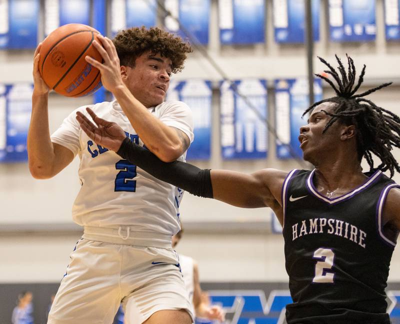 Burlington guard Caden West (2) drives the lane during a game at Burlington Central High School on Friday, Dec. 22, 2023.