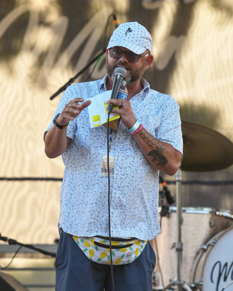 Master of Ceremony Joel Frieders talks between music groups during the Summer Solstice music festival held on Friday June 23, 2023 in downtown Yorkville.