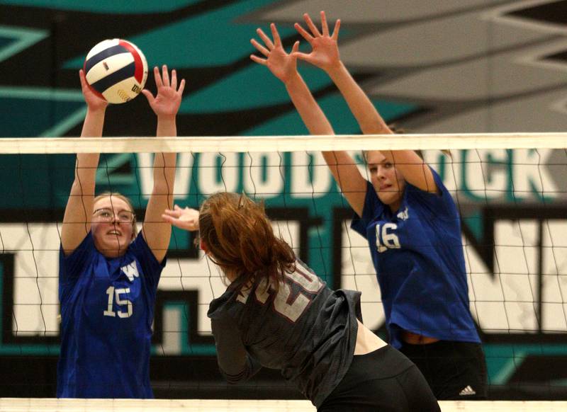 Woodstock’s Hailey Meyer, left, and Hallie Steponaitis, right, block against Prairie Ridge in IHSA Class 3A sectional semifinal volleyball action at Woodstock North Monday.