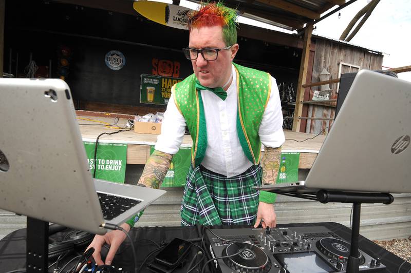 Donning his plaid kilt and orange and green hair, D.J. Ronnie, entertains the crowd after the Yorkville St. Patrick's Day parade on Hydraulic Avenue, Saturday, Mar. 16, 2024.
