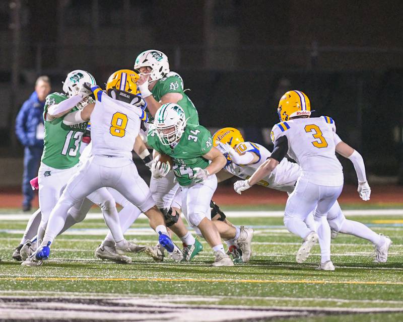 York High school Shane Trainer (34) runs the ball before being brought down during the first quarter on Friday Oct. 18, 2024, while taking on Lyons Township High School.