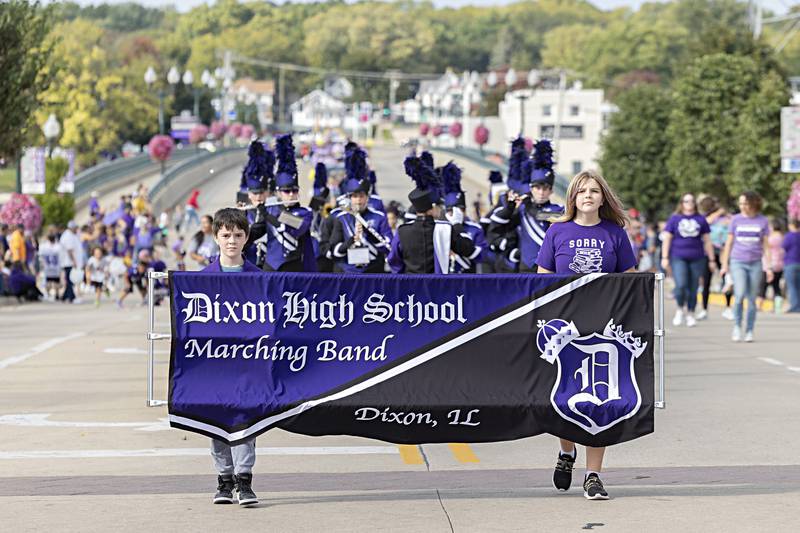 The Dixon marching band leads the homecoming parade across the Peoria Avenue bridge Friday, Sept. 29, 2023.