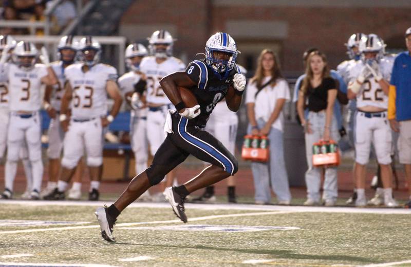 St. Charles North’s Joell Holloman runs the ball during a game against Wheaton North Friday, Sept. 13, 2024 at St. Charles North.