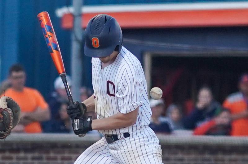 Oswego’s Anthony Comperda (9) is hit by a pitch during a baseball game against Yorkville at Oswego High School on Monday, April 29, 2024.