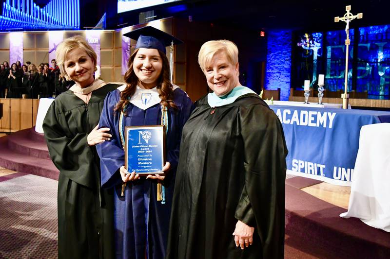 Nazareth Academy President Deborah Tracy and Principal Therese Hawkins congratulate Gianina Montoro, the 2024 Sr. Oliver Donlin Service Award recipient during the school’s commencement ceremony at Christ Church in Oak Brook on Sunday, May 19, 2024.