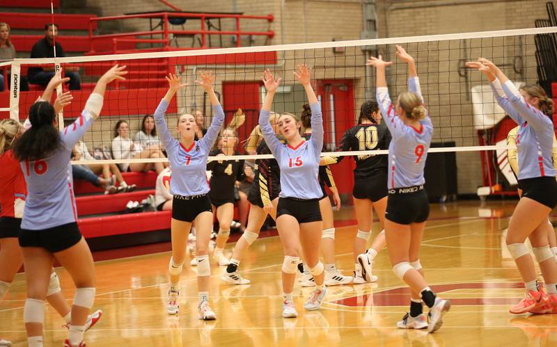 Members of the Ottawa volleyball team react after scoring a point against Morris on Tuesday, Sept. 12, 2023 in Kingman Gym at Ottawa High School.