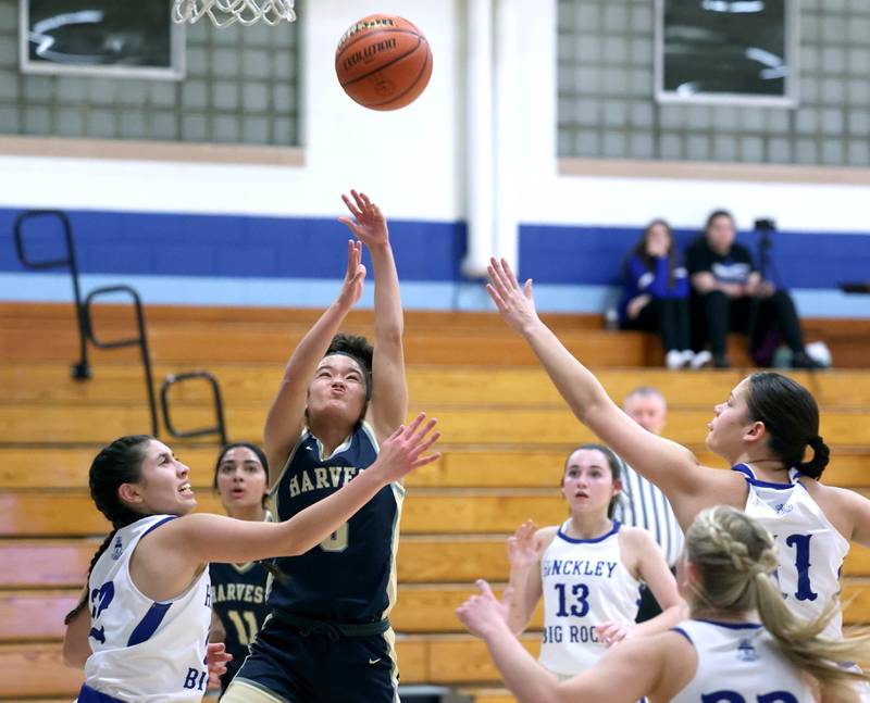 Harvest Christian’s Daphne Brown gets up a shot between three Hinckley-Big Rock defenders Monday, Jan. 8, 2023, during their game at Hinckley-Big Rock High School.