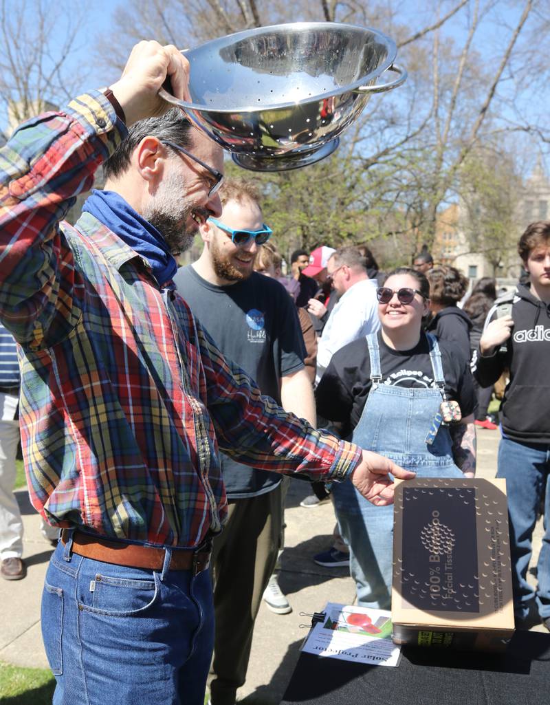 The eclipse is projected through the holes in a colander onto a box Monday, April 8, 2024, at the NIU Solar Eclipse Viewing Party behind Davis Hall in DeKalb. Attendees were treated to perfect weather to watch the rare celestial event.