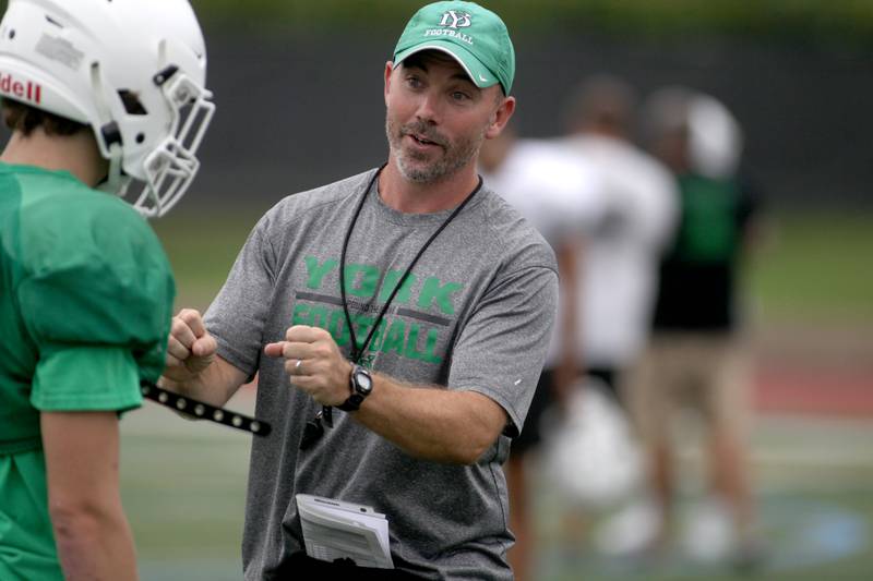 York Head Coach Mike Fitzgerald wirls with some of his team during practice at the Elmhurst school on Wednesday, Aug. 9, 2023.