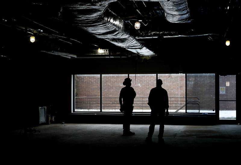 Construction workers walk inside the old Cary Village Hall, at 655 Village Hall Drive, in Cary, on Tuesday, Feb. 7, 2023. Work has started on converting the space into the McHenry County Sheriff's Office's new law enforcement training facility. The facility will allow local agencies to train closer to home.