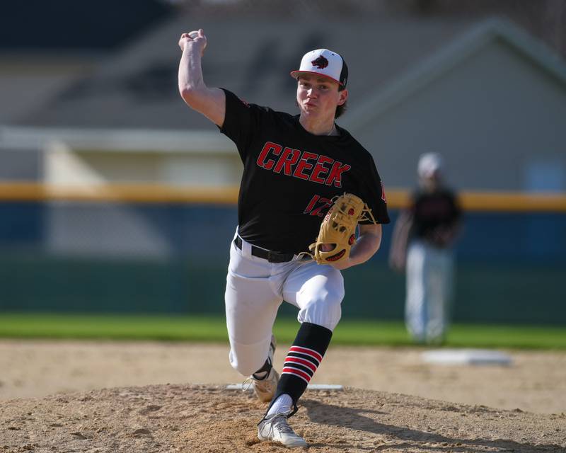 Indian Creek's Jakob McNally (12) pitches against Hiawatha on Friday April 12, 2024, at Hiawatha High School.