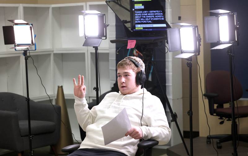 Gable Carrick, a junior at Sycamore High School and floor director for this broadcast, counts the news anchors down before they roll Wednesday, March 1, 2023, in the broadcast studio at the school.