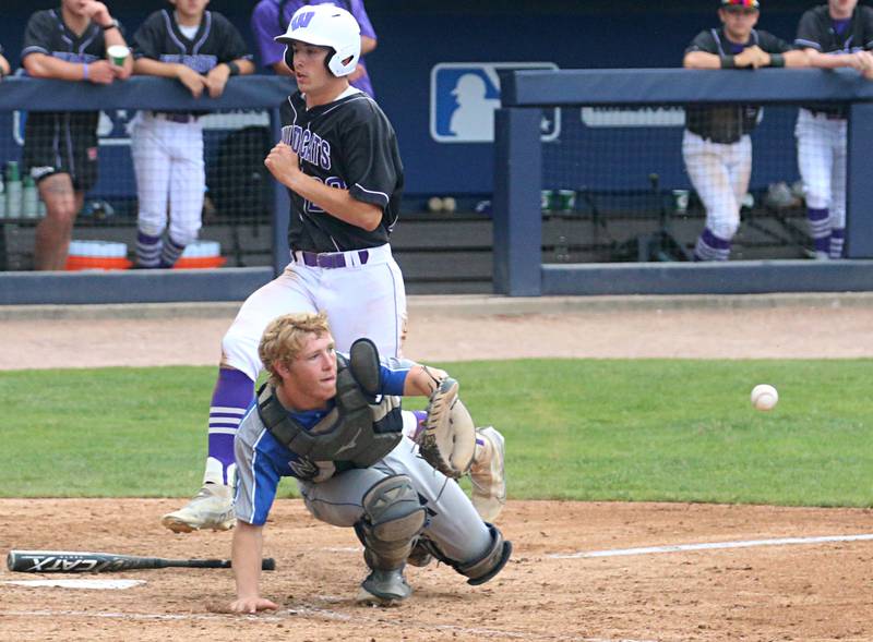 Wilmington's Ryan Kettman scores a run as the throw to the plate comes in late to Newman catcher Daniel Kelly during the Class 2A third place game on Saturday, June 1, 2024 at Dozer Park in Peoria.