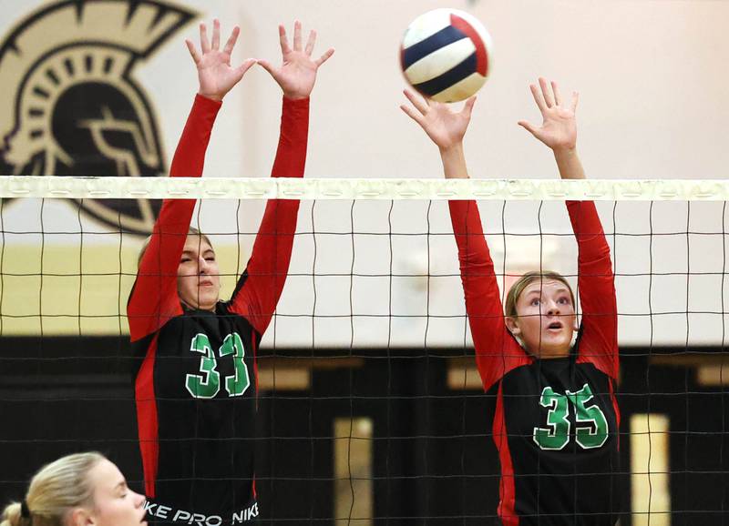 LaSalle-Peru's Kelsey Frederick (left) and Aubrey Duttlinger go after a block during their match Tuesday, Oct. 10, 2023, at Sycamore High School.