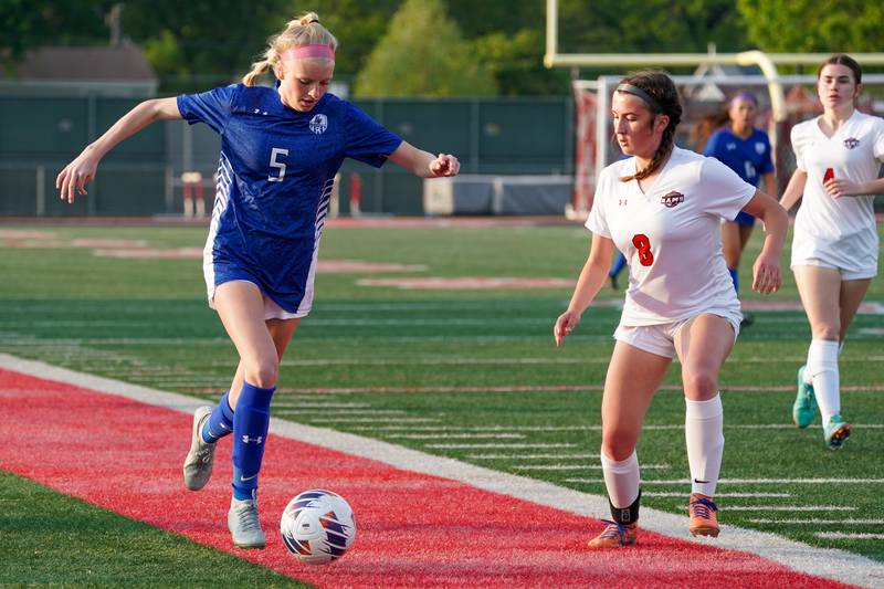 Geneva’s Audrey Stredde (5) plays the ball against Glenbard East's Makenna Gibbons (8) during a Class 3A Glenbard East Regional semifinal soccer match at Glenbard East High School in Lombard on Tuesday, May 14, 2024.