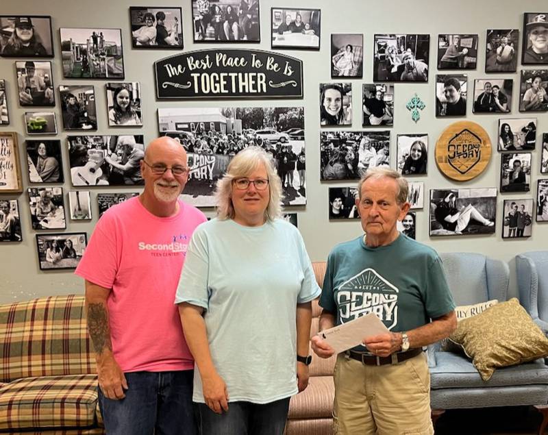 Don J. Schiff (Right) presents his donation of $50,000 to the Second Story Teen Center to Founders Dana (Center) and Jeff (Left) Van Autreve.